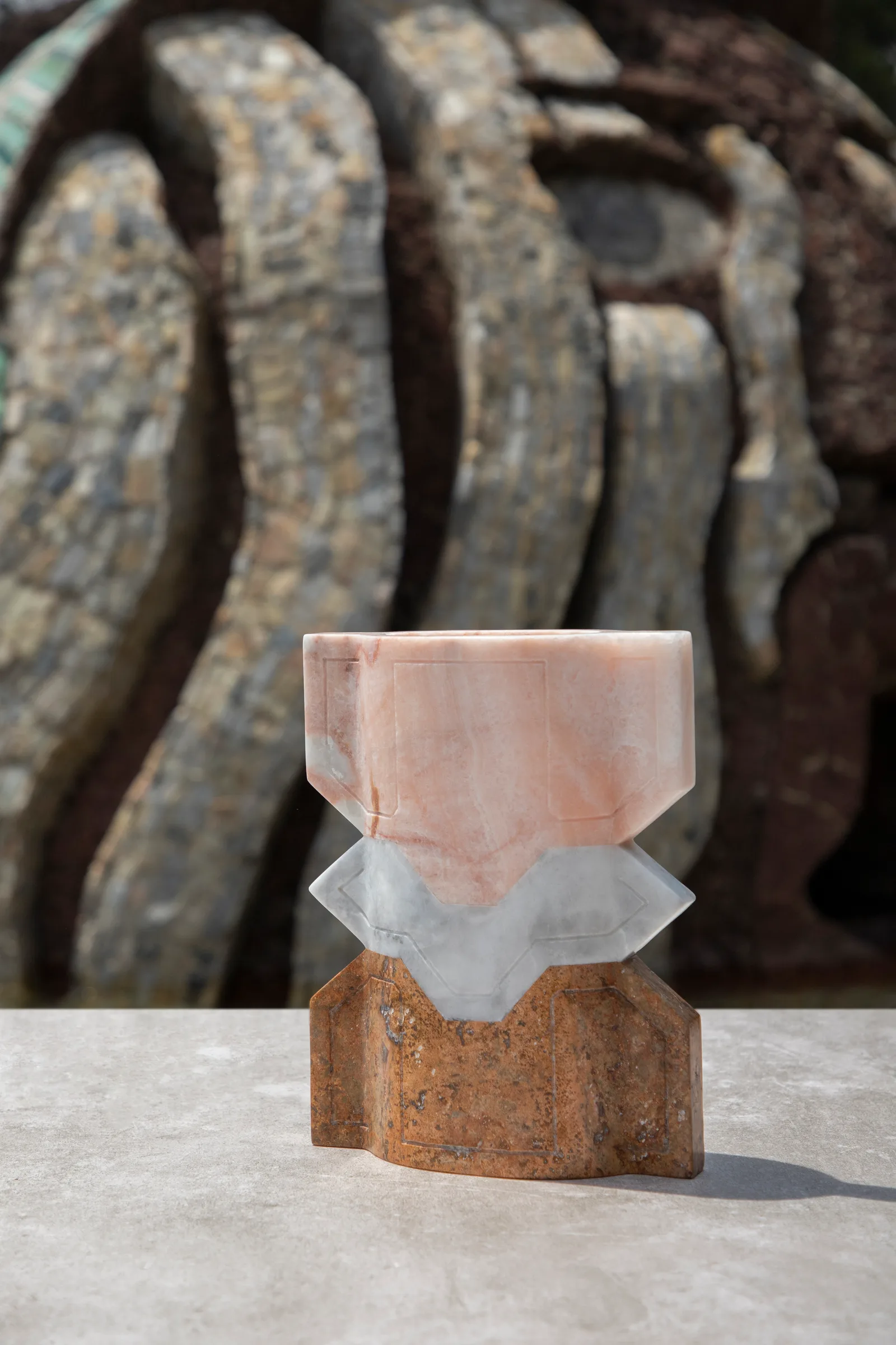 Místico II.II vase in pink onyx, venetian marble, red travertine — exhibition view