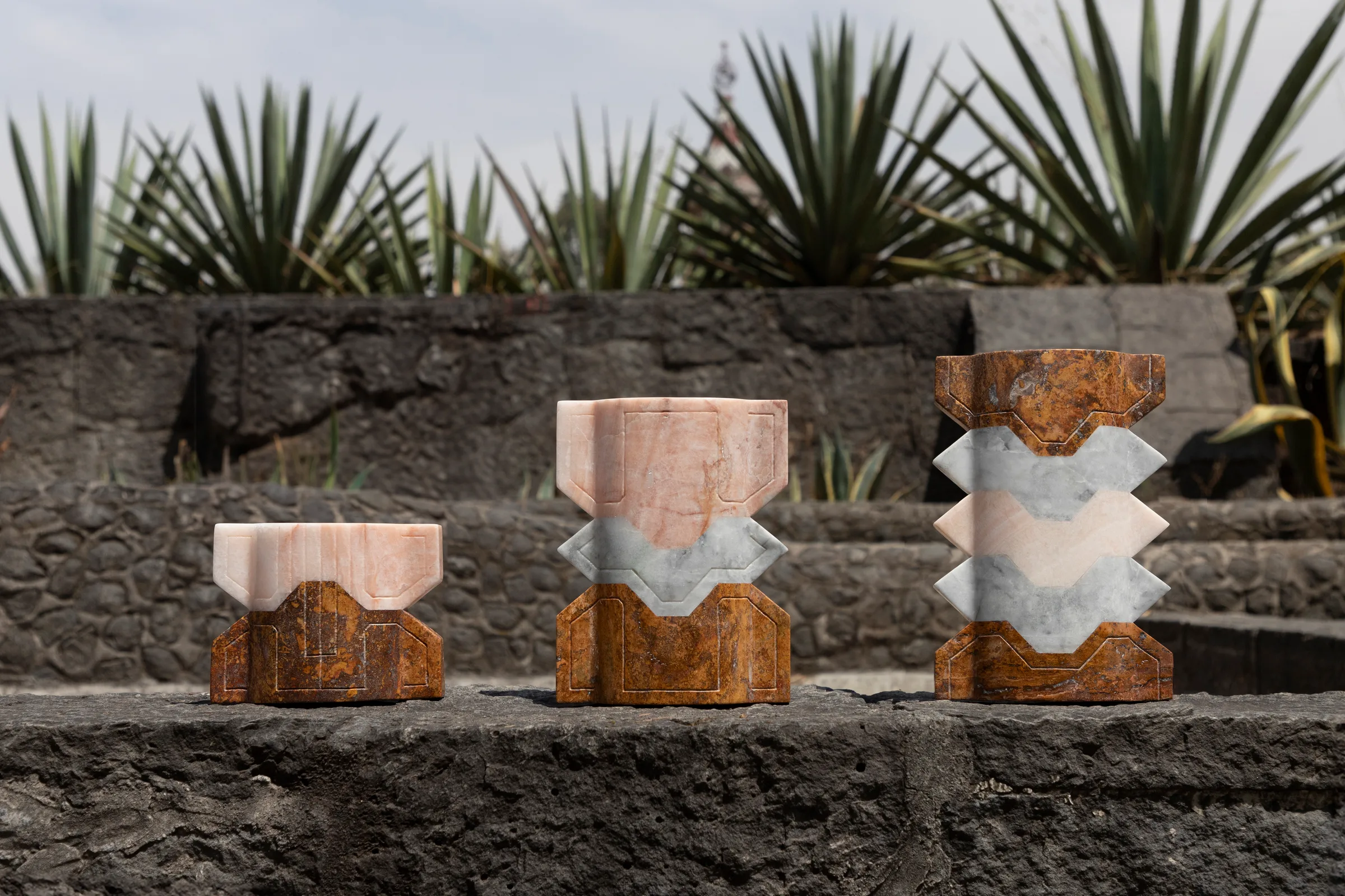 Místico II.II vase in pink onyx, venetian marble, red travertine — studio view