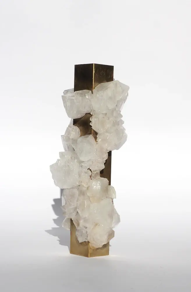 Brass sculpture colonized by calcite crystals, vertical totem form
