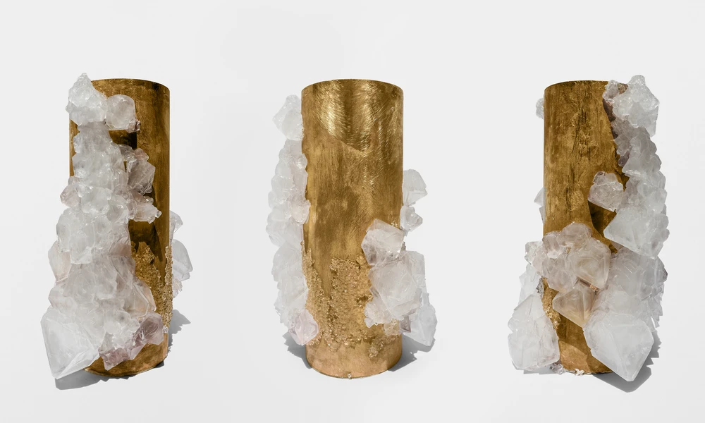 Three views of a brass sculpture colonized by crystals